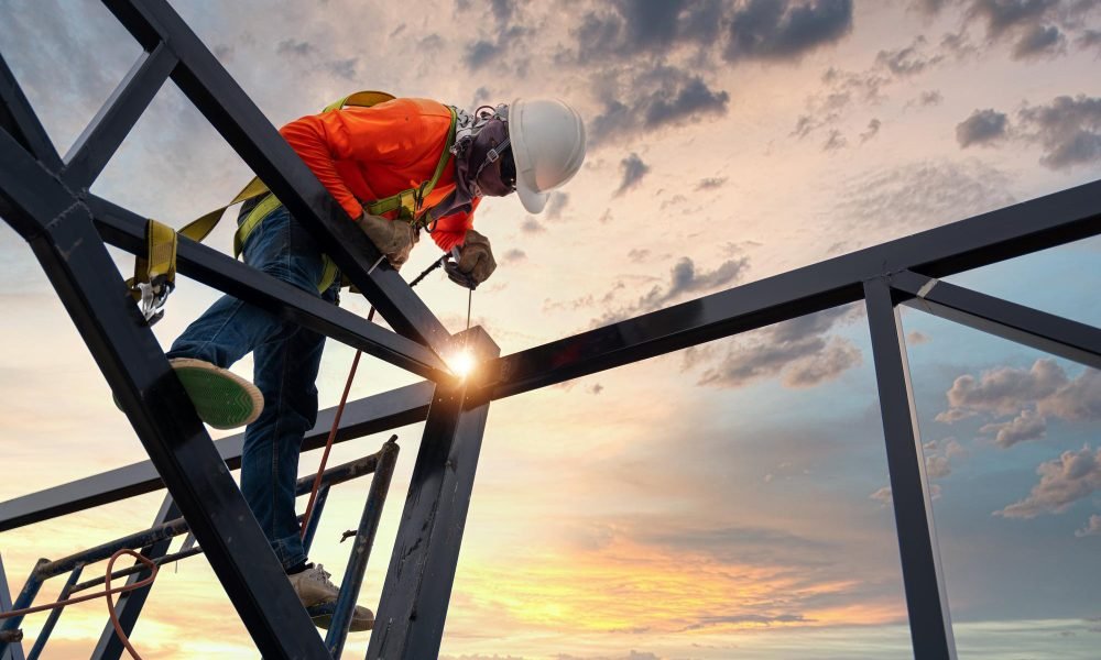 welder-is-welding-steel-steel-roof-truss-working-height-equipment-fall-arrestor-device-worker-with-hooks-safety-body-harness-worker-construction-site